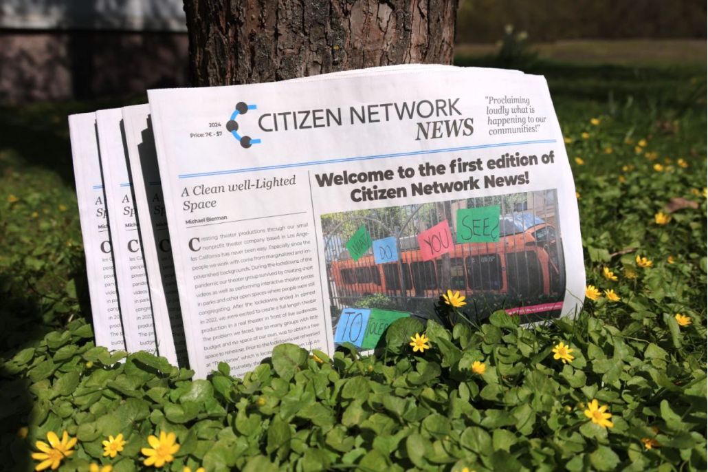 Kuvassa sanomalehti kukkien keskellä nurmikolla – Citizen Network News on uusi kansainvälinen sanomalehti